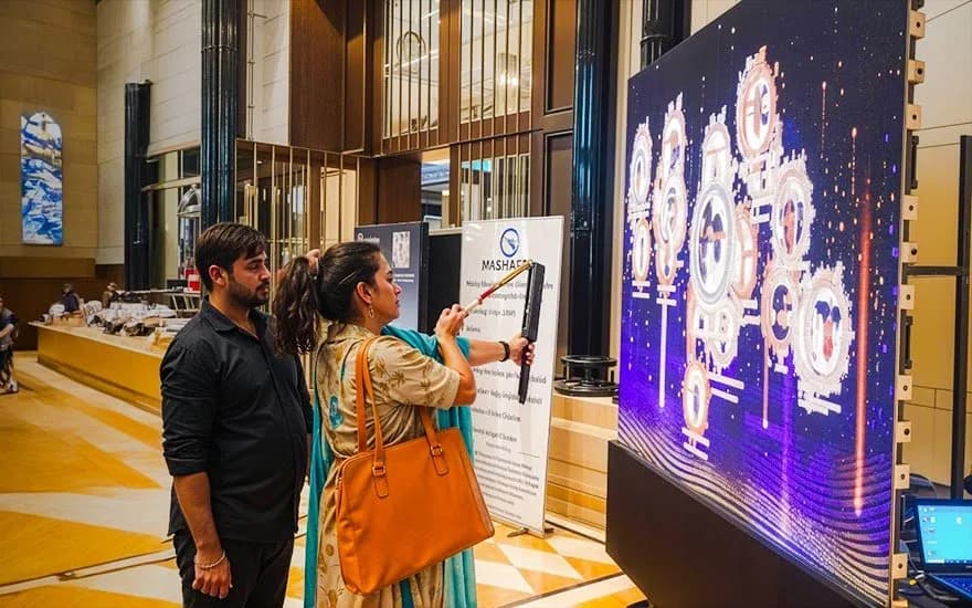 Visitors at a custom-built interactive LED installation on an event floor