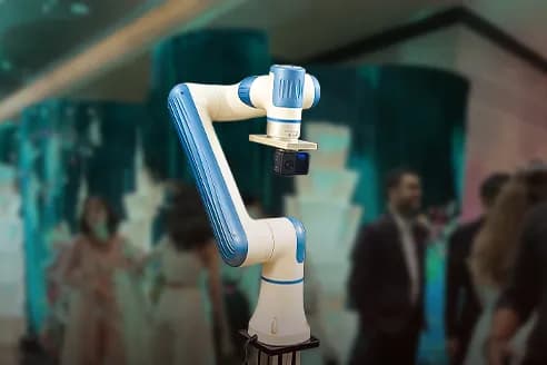 Glambot robotic camera arm sweeping past a guest